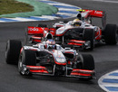 Jenson Button and Lewis Hamilton on track
