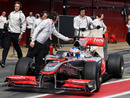 Jenson Button returns to the pits in his McLaren