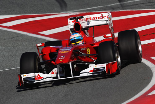 Fernando Alonso dives into the pit lane
