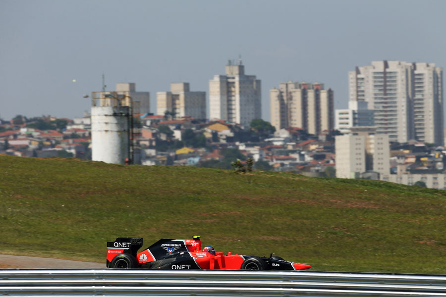 Charles Pic on track in front of the Sao Paulo skyline