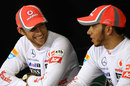 Jenson Button and Lewis Hamilton share a joke in the post-race press conference