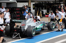 Michael Schumacher is wheeled in to the garage after being eliminated from Q2