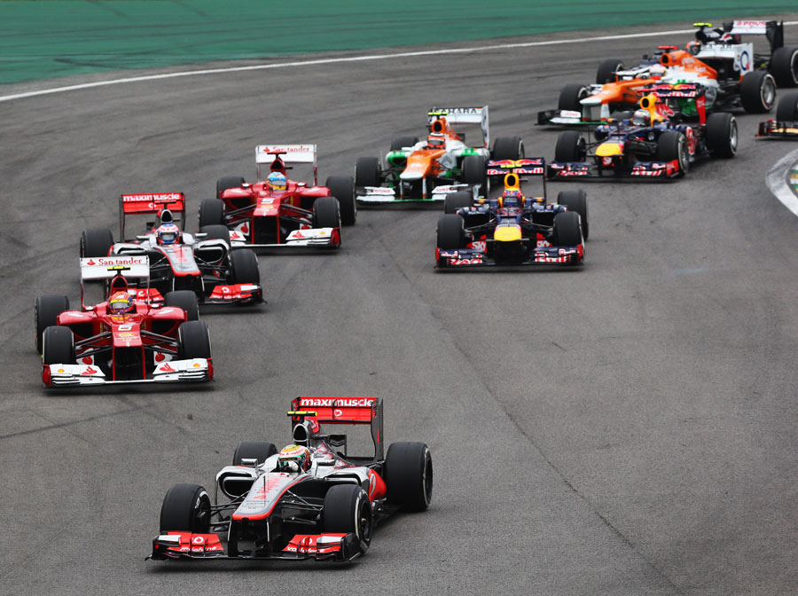 Lewis Hamilton leads the pack through turn one as Sebastian Vettel loses ground at the start