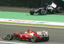 Fernando Alonso passes by Pastor Maldonado's crashed Williams