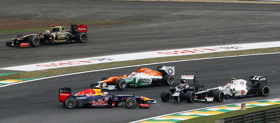 Sebastian Vettel ends up going backwards after colliding with Bruno Senna  at the start