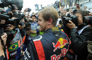 Sebastian Vettel is met by a bank of photographers after winning his third world title