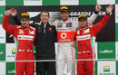 Jenson Button takes the plaudits flanked by a brace of Ferrari drivers