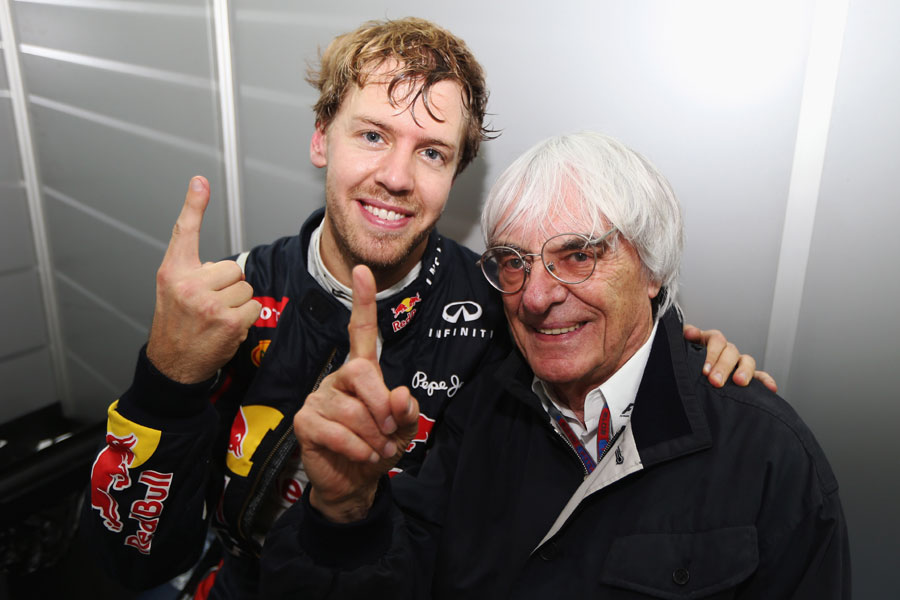 Sebastian Vettel celebrates his third world title with Bernie Ecclestone