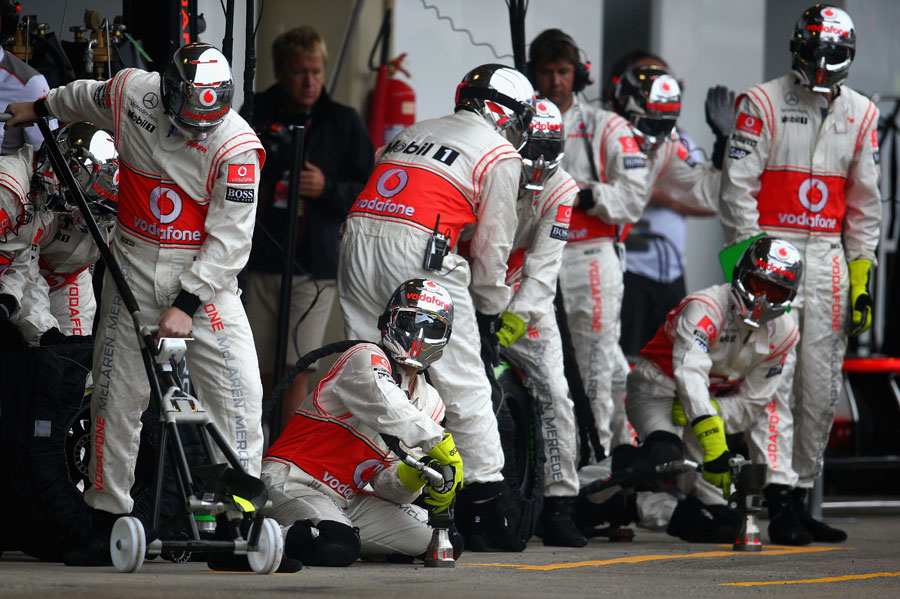 The McLaren team prepares for a pit stop