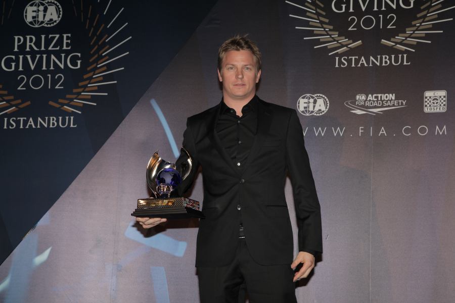 Kimi Raikkonen receives his award for third place in the drivers' championship at the FIA prize-giving gala