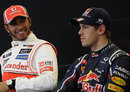 Lewis Hamilton cracks a smile at Sebastian Vettel during the post-qualifying press conference