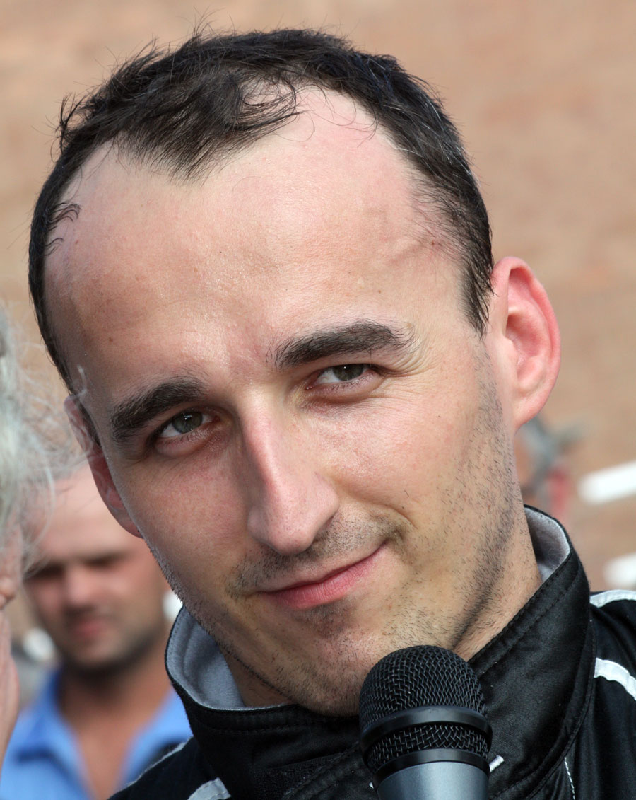 Robert Kubica celebrates his victory on the podium