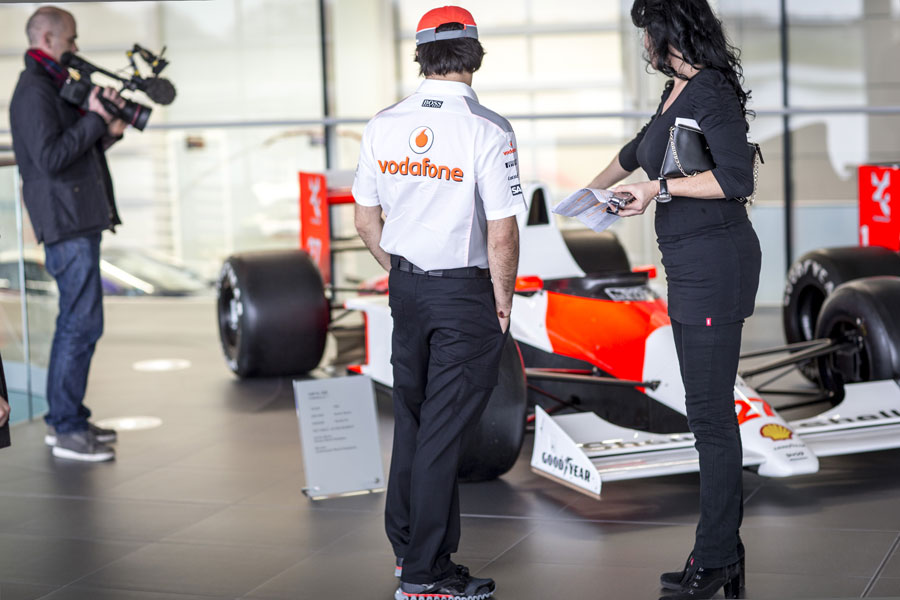 Sergio Perez takes a look at the cars on display on his first day at McLaren