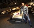 Lewis Hamilton poses for a photo with the championship-winning Mercedes W196