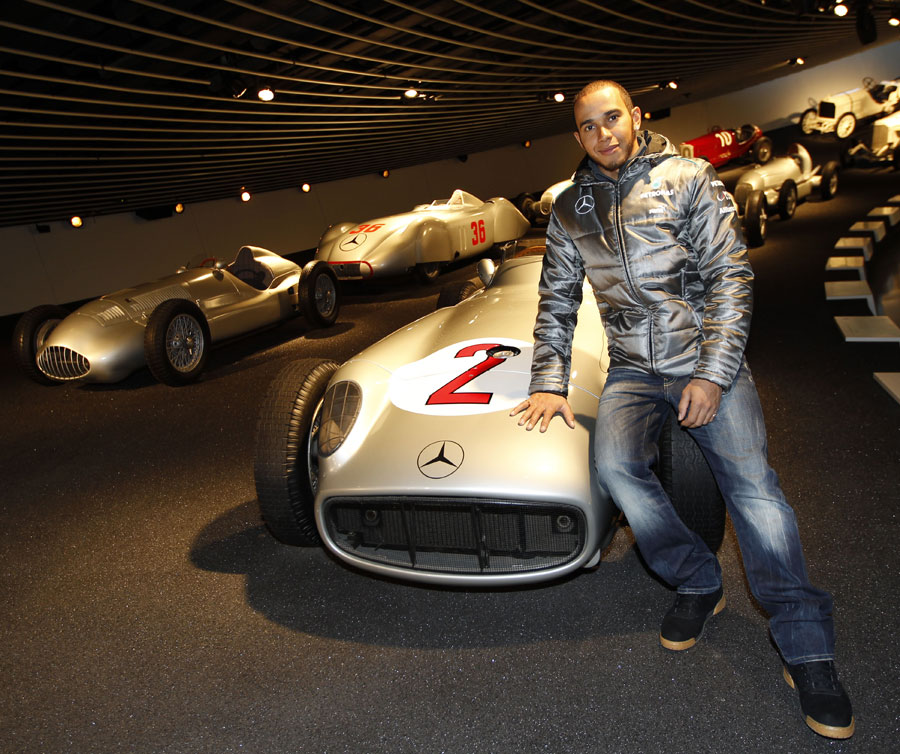Lewis Hamilton poses for a photo with the championship-winning Mercedes W196