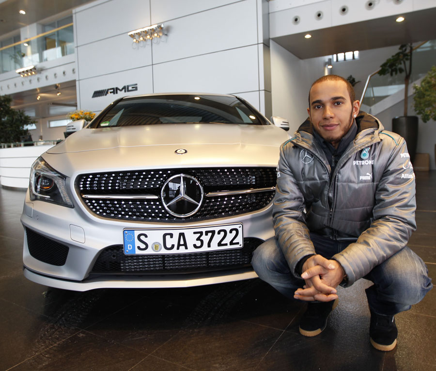 Lewis Hamilton poses with a Mercedes road car