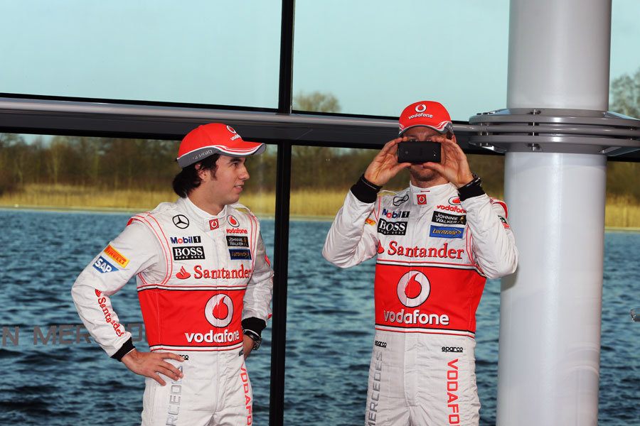 Jenson Button takes a photo at the launch of the McLaren MP4-28