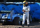 Lewis Hamilton walks away from his car after crashing at turn six