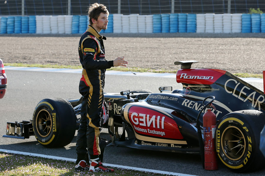Romain Grosjean stands by his car after it ran out of fuel at the end of the day