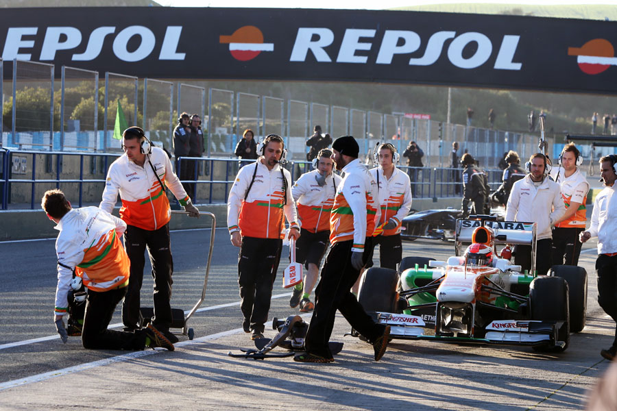 A Force India mechanic recovers after being hit by James Rossiter's Force India