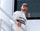 Lewis Hamilton is all smiles as he prepares to speak to the press