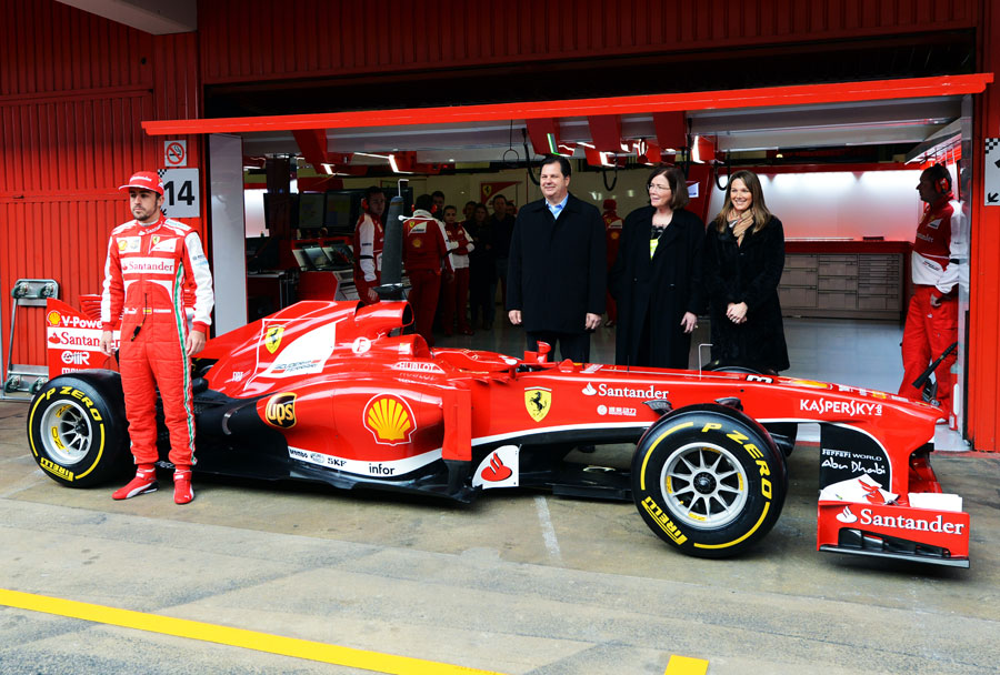 Fernando Alonso poses for a photo alongside Ferrari's new sponsors UPS