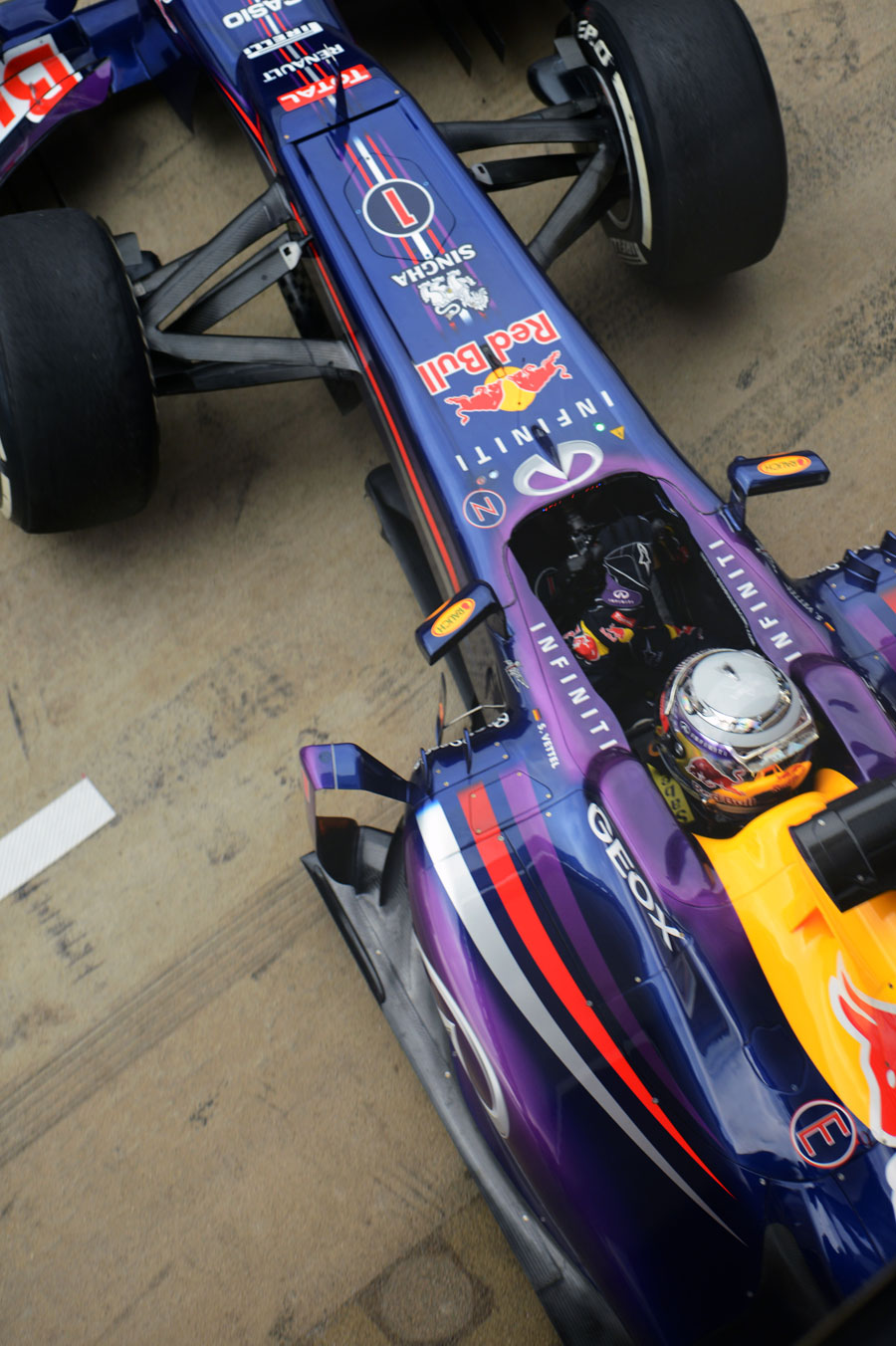 Sebastian Vettel leaves the Red Bull garage in the RB9