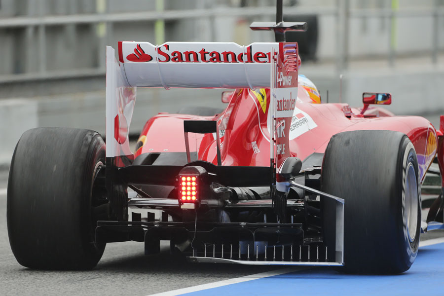 Fernando Alonso heads out on track with a measuring device attached to the Ferrari's diffuser