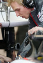 A Sauber engineer works on the C32's passive drag reduction device