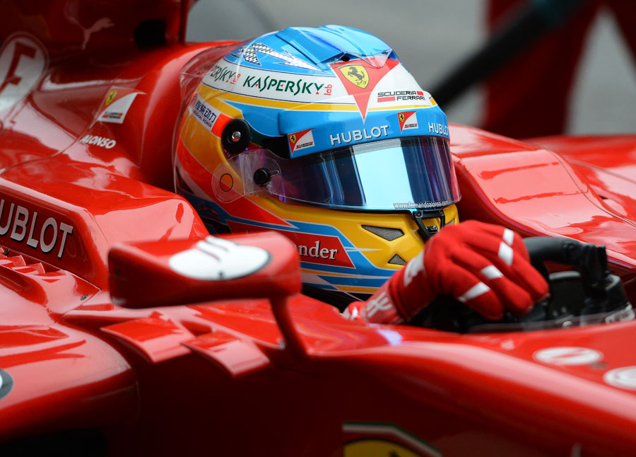 Fernando Alonso returns to the garage in the Ferrari