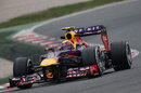 Mark Webber attacks the Barcelona circuit in the Red Bull 