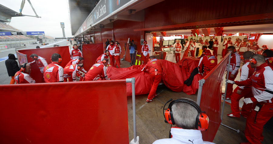 Felipe Massa's Ferrari being brought home after sliding off