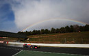 Mark Webber in the wet and with a rainbow