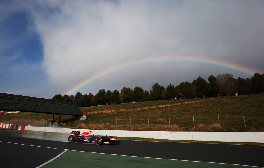 Mark Webber in the wet and with a rainbow