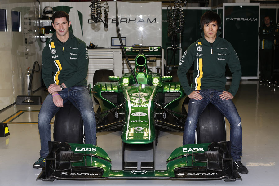 New Caterham reserve drivers Alexander Rossi and Ma Qing Hua pose with the CT03