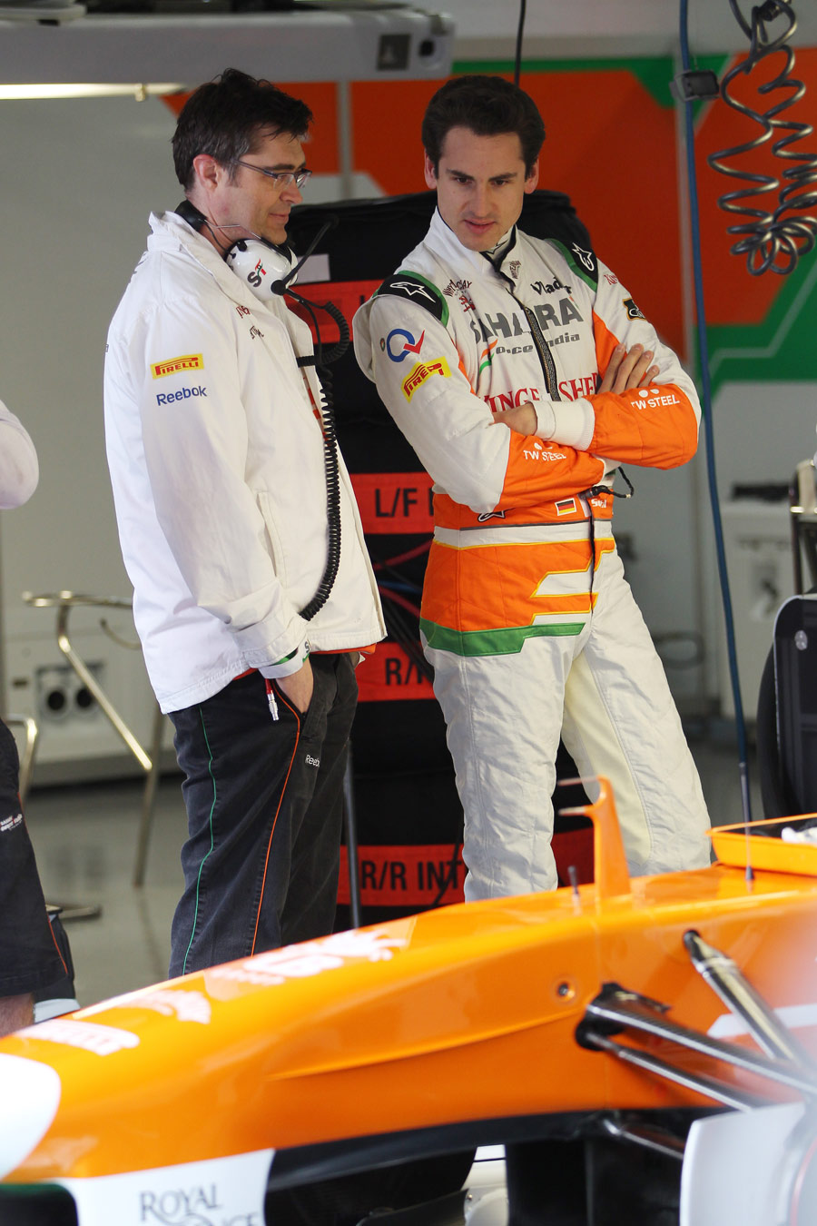 Adrian Sutil looks at the detail on the Force India