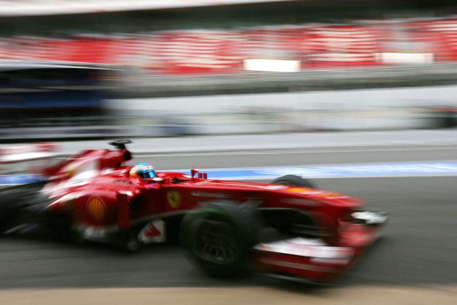 Fernando Alonso's Ferrari arrives in the pits