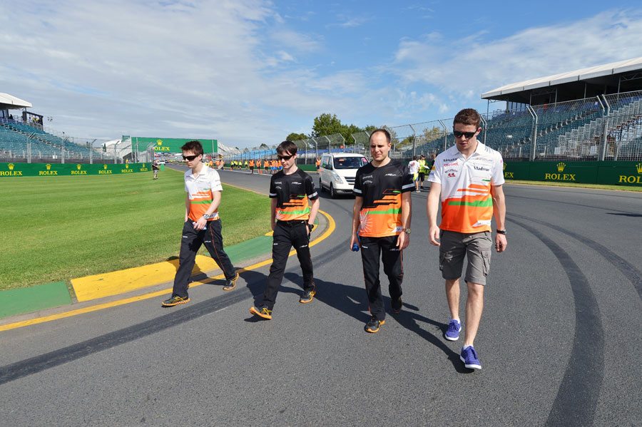 Paul di Resta walks the track with his Force India engineers