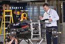 A member of the FIA checks over one of the Red Bulls