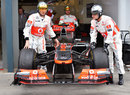 Sergio Perez's McLaren is wheeled towards scrutineering