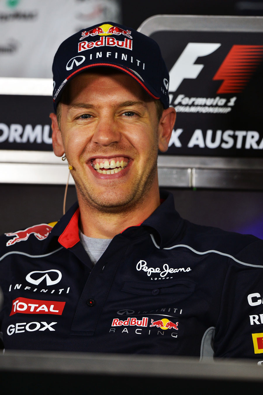 Sebastian Vettel enjoys a joke in the driver press conference