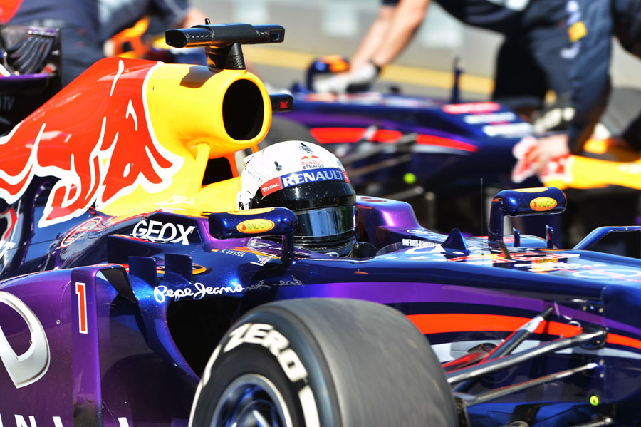 Sebastian Vettel is wheeled back in to the Red Bull garage