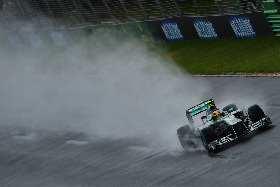 Lewis Hamilton cuts through the spray during a messy Q1