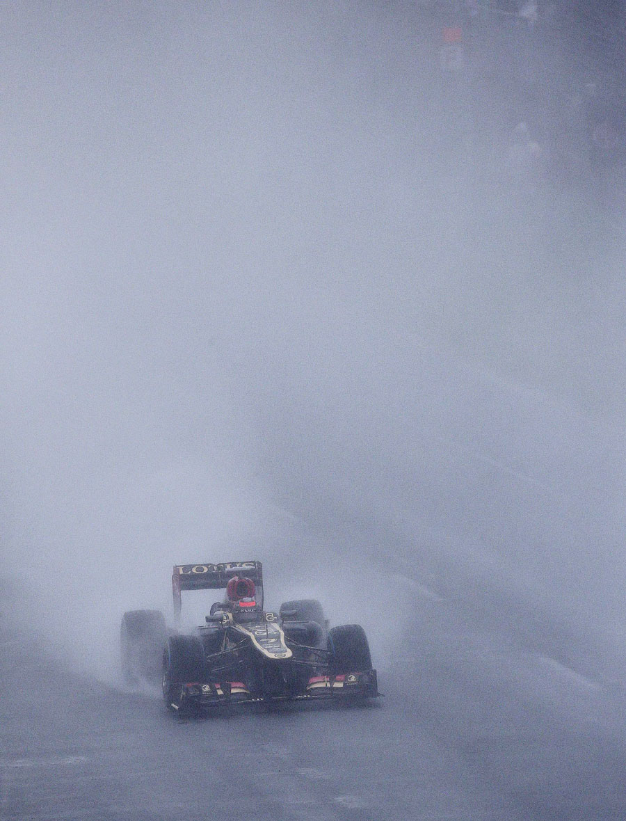 Kimi Raikkonen cuts through the gloom and the rain