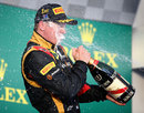 Kimi Raikkonen gets a soaking on the podium