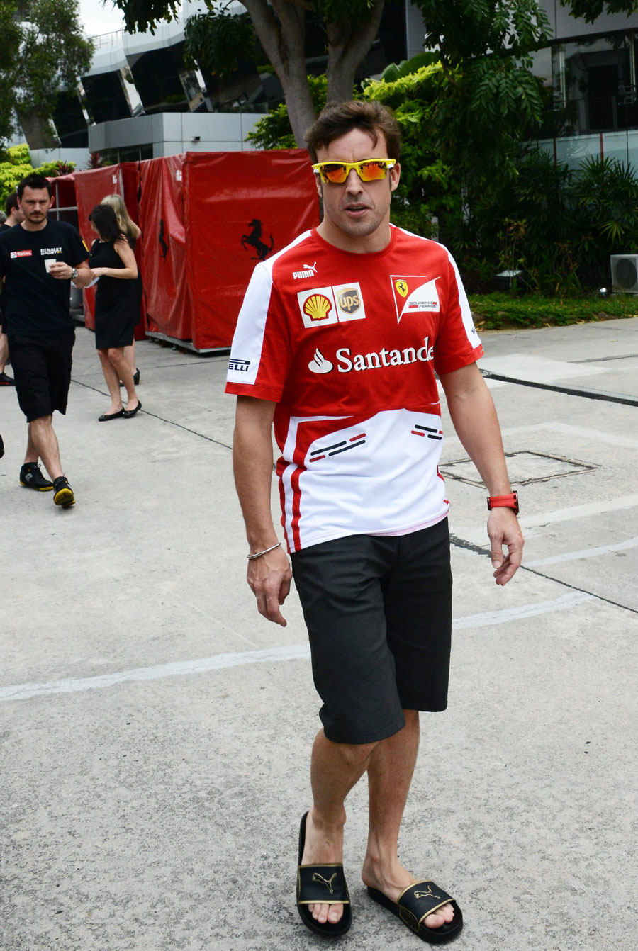 Fernando Alonso walks through the Malaysian paddock
