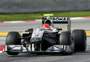 Michael Schumacher lifts a wheel in the Mercedes