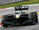 Heikki Kovalainen lifts a wheel in the Lotus
