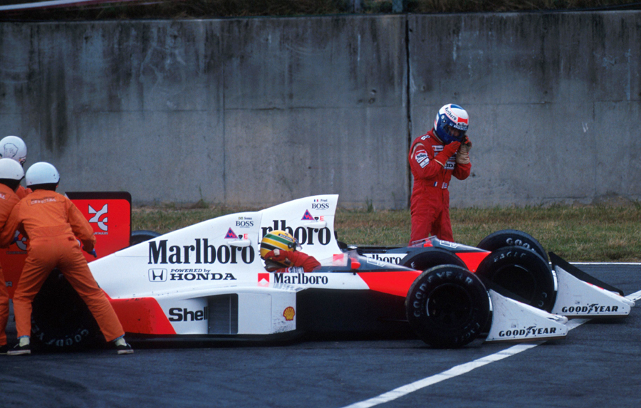 Alain Prost walks away from his McLaren following a collision with team-mate Ayrton Senna