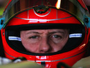 Michael Schumacher looks down the lens of a photographer